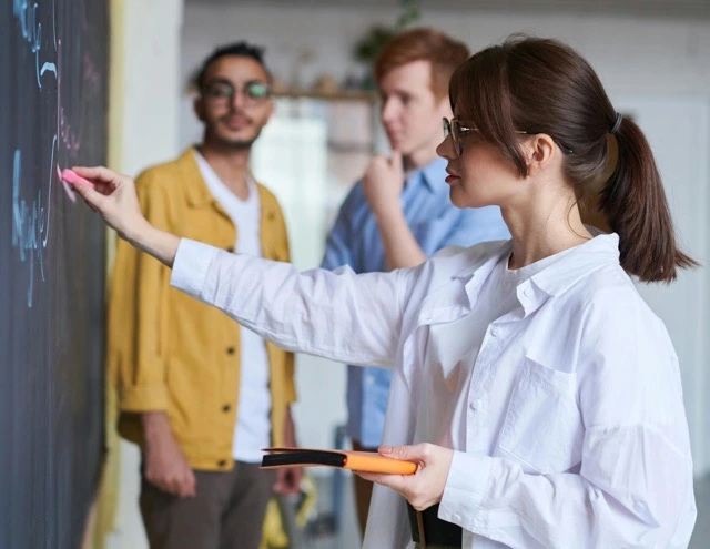 woman writing on a blackboard